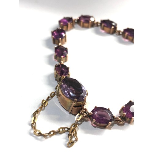 333 - 9ct gold amethyst coloured gem set bracelet