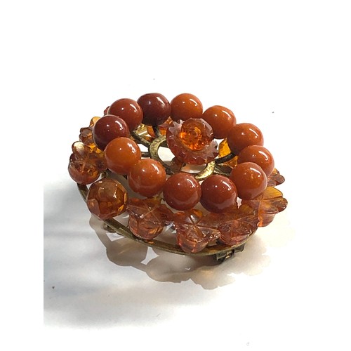 257 - carved amber bead brooch