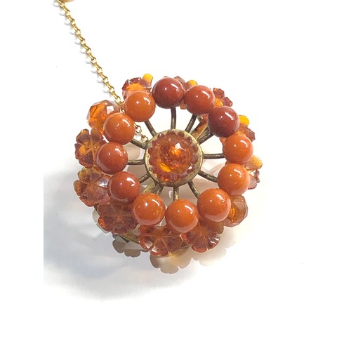 257 - carved amber bead brooch