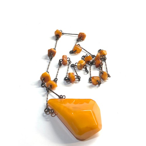 61 - large egg yolk amber pendant and  amber bead necklace