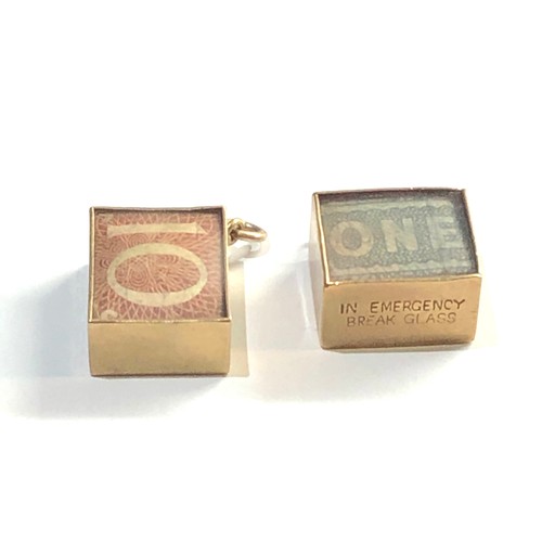 293 - 9ct Gold break money in emergancy charms