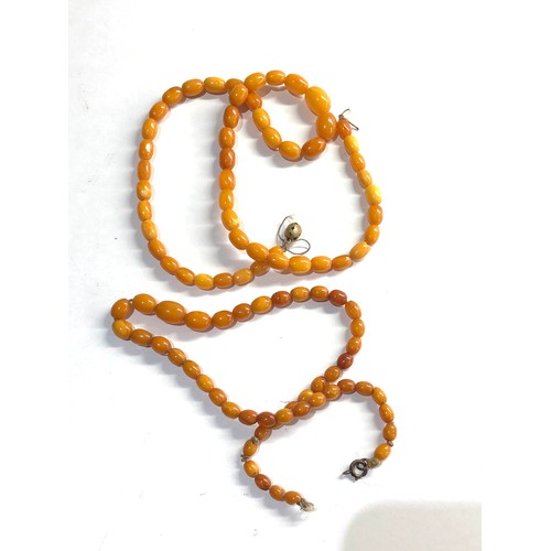 304 - 2 egg yolk amber bead necklaces 26g