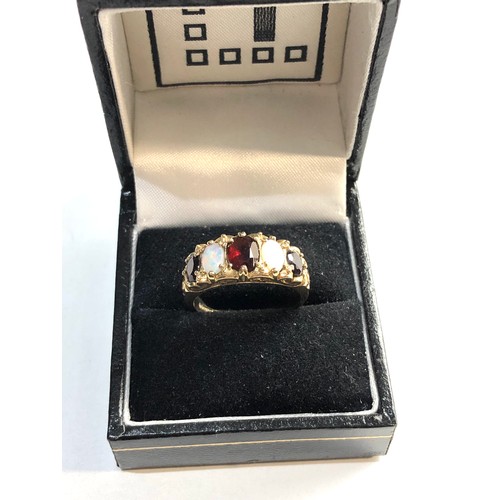 233 - 9ct gold garnet and opal ring, Good overall condition, no stones missing ring size approx Q