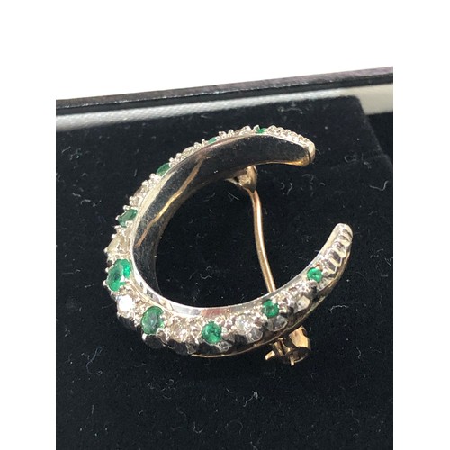 63 - Vintage gold Diamond and emerald crescent brooch measures approx 2.8cm by 2.7cm weight 7g