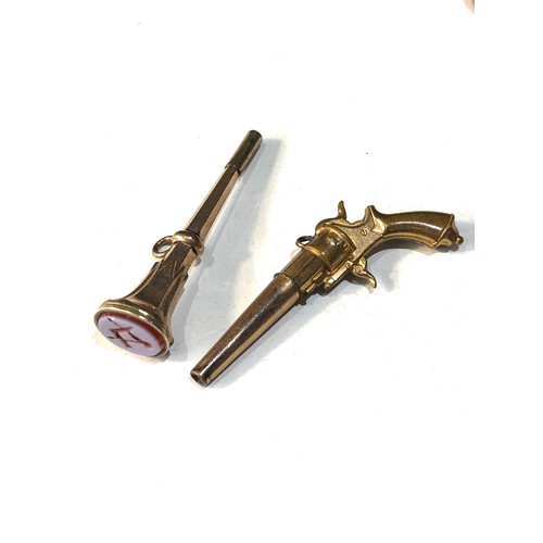 92 - 2 antique novelty watch keys includes gun and a masonic hard stone intaglio