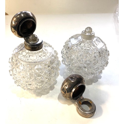 31 - Pair of antique silver top perfume bottles the silver tops are in need of restoration dents and mark... 