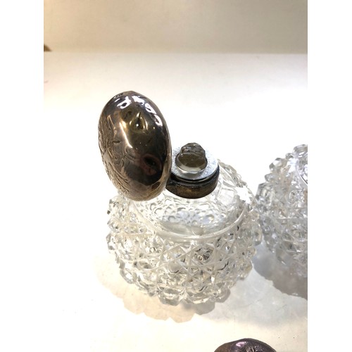 31 - Pair of antique silver top perfume bottles the silver tops are in need of restoration dents and mark... 