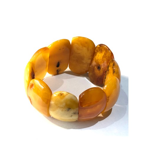 213 - Egg yolk amber bracelet each panel measures approx 4.2cm by 2.6cm wide weight 57g