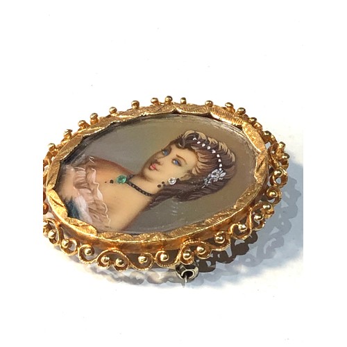 115 - 18ct gold framed hand painted miniature with diamond  and jewel set accents measures approx 3.7cm by... 