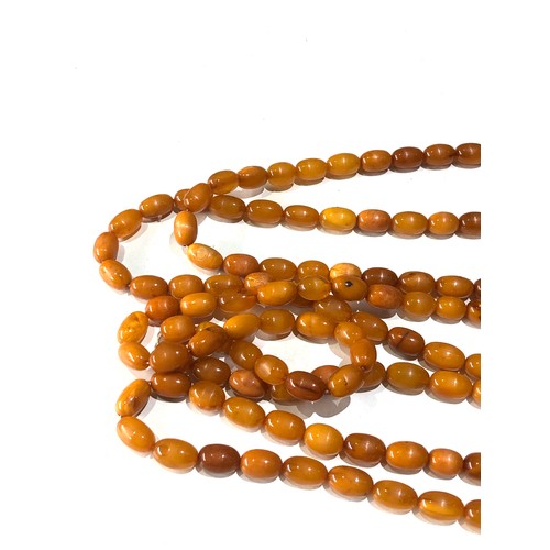 70 - Long antique egg yolk amber bead necklace measures approx 176cm long even sized beads measures appro... 