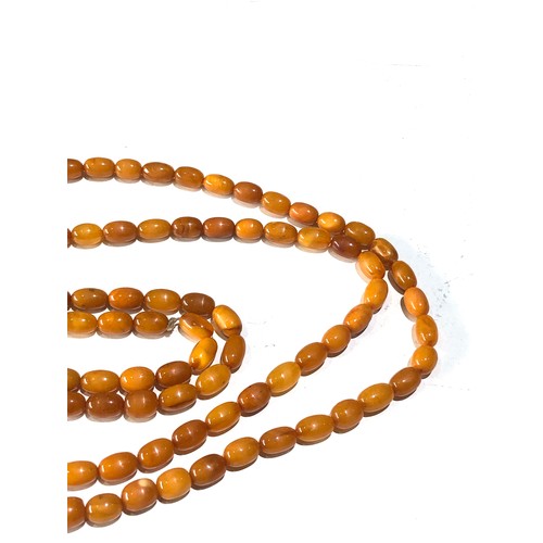 70 - Long antique egg yolk amber bead necklace measures approx 176cm long even sized beads measures appro... 