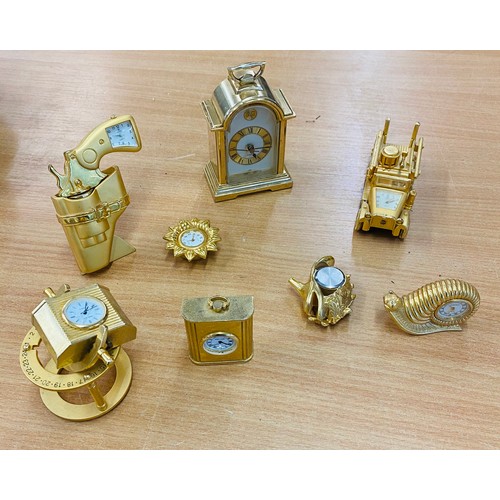 131 - Selection of 8 miniature gold tone novelty collectable mantle clocks, all untested