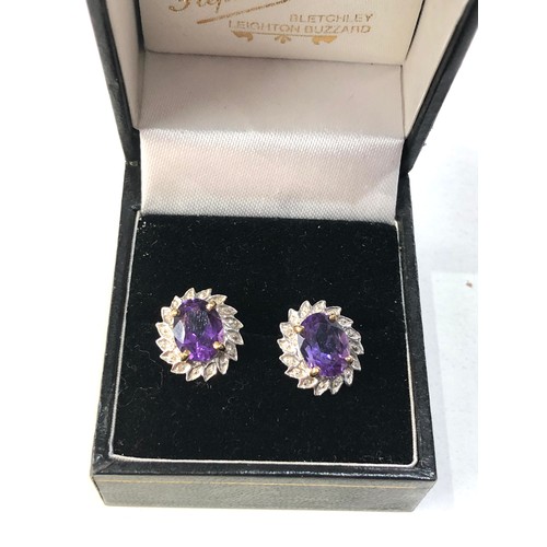 185 - 9ct gold amethyst halo earrings measure approx 1.5cm by 1.2cm weight 2.5g