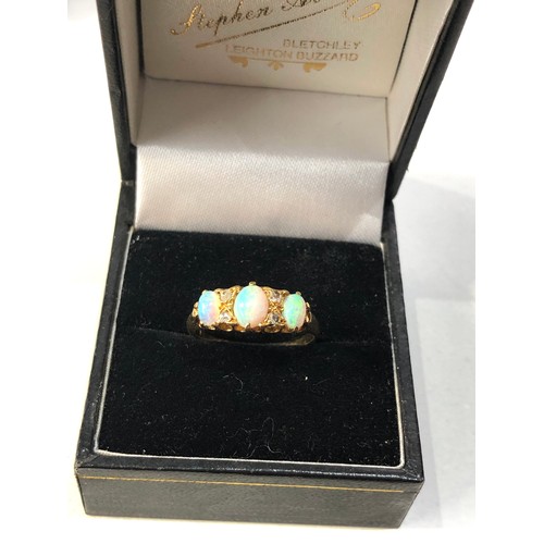 353 - Fine 18ct gold opal and diamond ring central opal measures approx 6mm by 4mm with 4 old cut rose dia... 