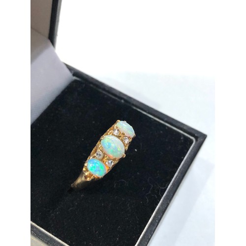 353 - Fine 18ct gold opal and diamond ring central opal measures approx 6mm by 4mm with 4 old cut rose dia... 