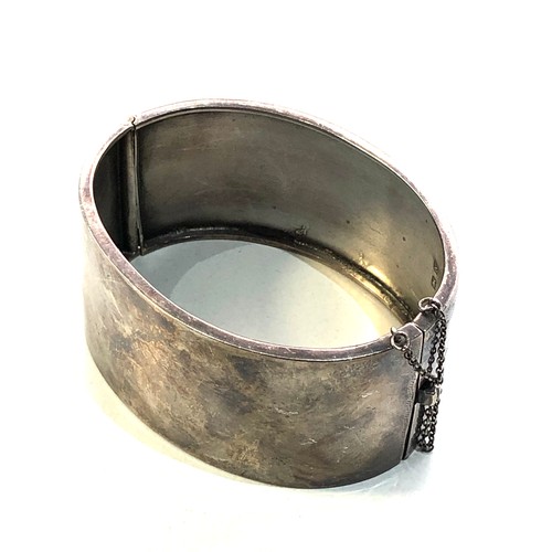 471 - Victorian silver and gold inlaid cuff bangle measures approx 6.5cm by 5.3cm and 3.1cm wide in good c... 