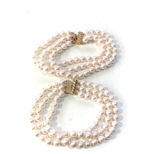 393 - 2 14ct gold clasp cultured pearl bracelets weight 88g