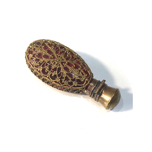 487 - Antique ruby glass perfume bottle complete with stopper measures approx 75mm by 30mm gilt metal lid ... 