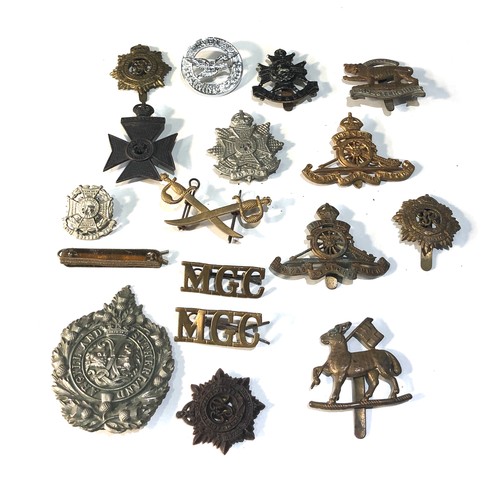 444 - Selection of military cap badges shoulder title etc