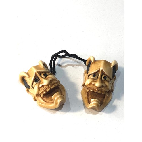 509 - 2 Japanese ivory noh mask netsuke of Hannya each measures approx 3.3cm by 2cm attached to a cord