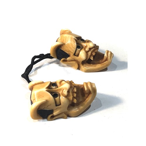 509 - 2 Japanese ivory noh mask netsuke of Hannya each measures approx 3.3cm by 2cm attached to a cord