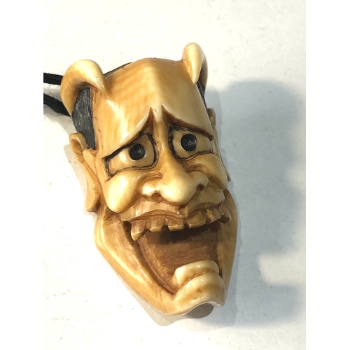 509 - 2 Japanese ivory noh mask netsuke of Hannya each measures approx 3.3cm by 2cm attached to a cord