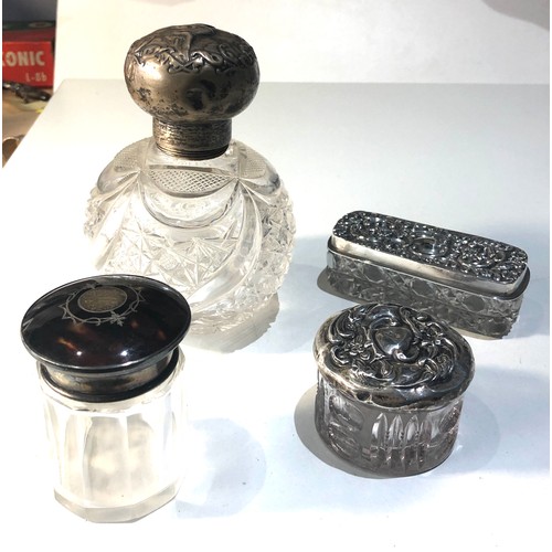 46 - Selection of 4 silver top bottles includes tortoiseshell top 2 trinket jars and a large silver perfu... 
