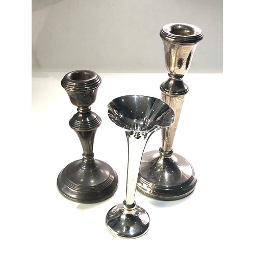 31 - 3 silver items includes 2 single candlesticks and a silver bud vase largest candle stick measures ap... 