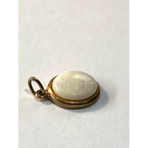 138 - Small 9ct gold opal charm pendant measures approx 1.6cm drop by 1.1cm wide weight 1.5g