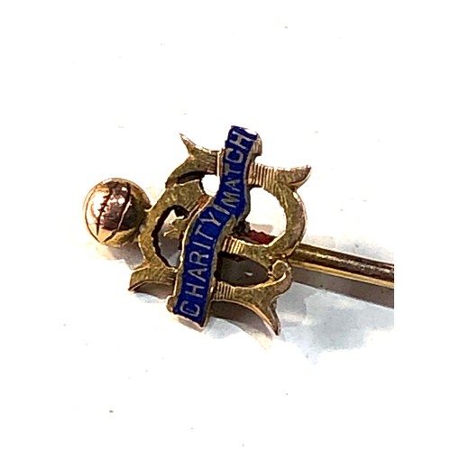 256 - 9ct gold enamel football charity match stick pin measures approx 5.7cm long weight 1.1g