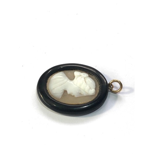 98 - Antique jet hard stone cameo pendant measures approx 2.7cm by 2.2cm damage as shown