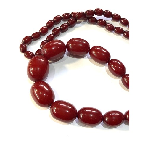 131 - Cherry amber bakelite necklace weight 134g no internal streaking largest bead measures approx 32mm b... 