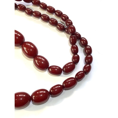 131 - Cherry amber bakelite necklace weight 134g no internal streaking largest bead measures approx 32mm b... 