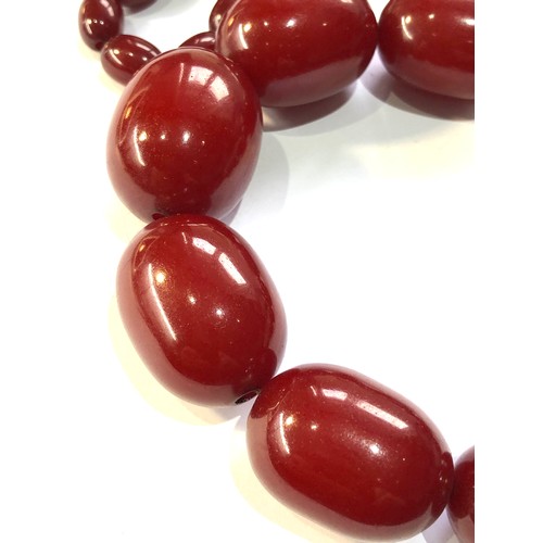 131 - Cherry amber bakelite necklace weight 134g no internal streaking largest bead measures approx 32mm b... 