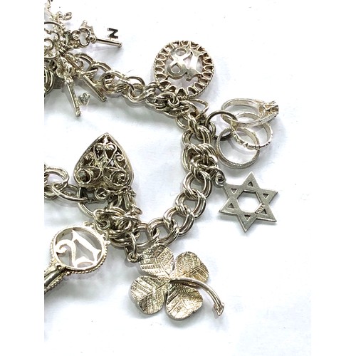 379 - Silver charm bracelet and charms weight 30g