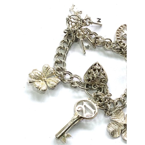 379 - Silver charm bracelet and charms weight 30g