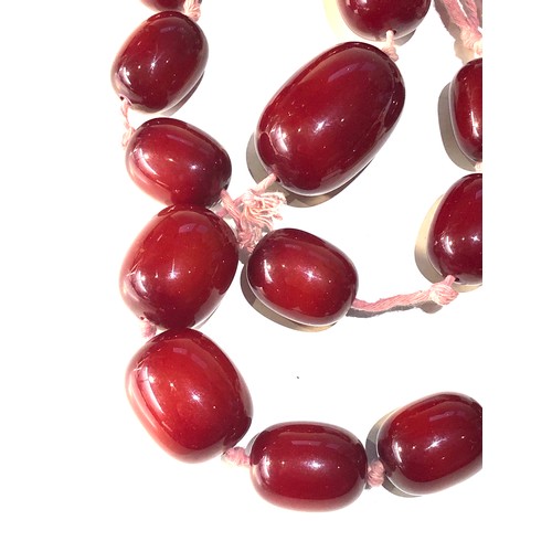 405 - large cherry amber / bakelite type bead necklace  largest bead measures approx 41mm by 28mm  weight ... 