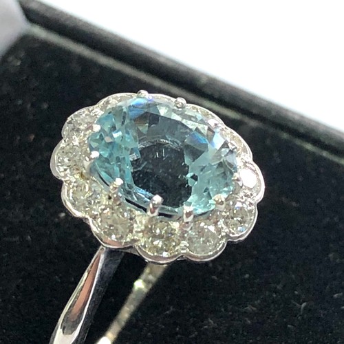 94 - Fine Diamond and aquamarine ring central aquamarine 2ct with a halo of diamonds around hallmarked 18... 