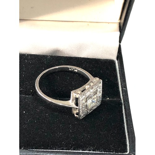 110 - Platinum and diamond ring central diamond measures approx 4mm by 4mm with diamond halo weight of rin... 