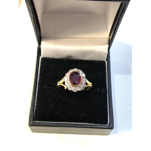 113 - Fine 18ct gold ruby and diamond halo ring set with central ruby 7mm by 6mm with halo of diamonds est... 