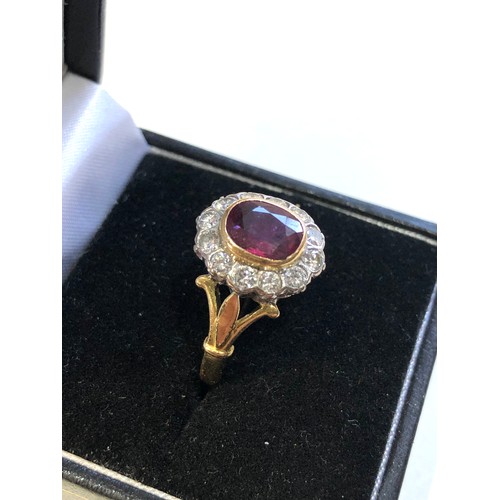 113 - Fine 18ct gold ruby and diamond halo ring set with central ruby 7mm by 6mm with halo of diamonds est... 