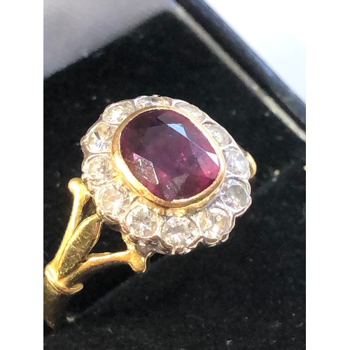 113 - Fine 18ct gold ruby and diamond halo ring set with central ruby 7mm by 6mm with halo of diamonds est... 