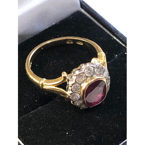 113 - Fine 18ct gold ruby and diamond halo ring set with central ruby 7mm by 6mm with halo of diamonds est... 