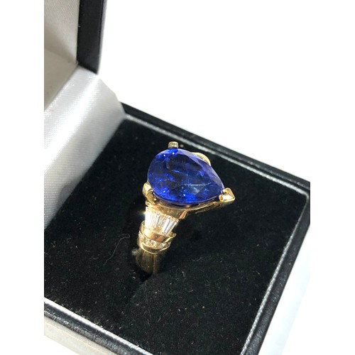 106 - Fine 18ct gold diamond and tanzanite  ring set with large central tanzanite measures approx 13mm by ... 