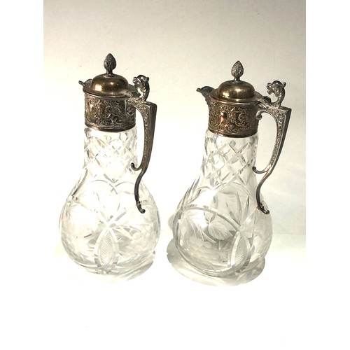 101 - Large pair of cut glass and silver pated claret jugs in good antique condition each measures approx ... 