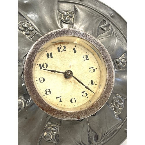 554 - Liberty & Co Tudric pewter desk clock, of circular easel form, with embossed foliate decoration, sta... 