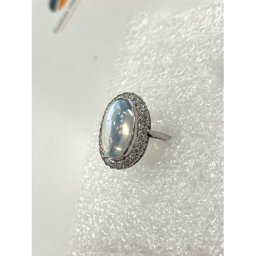 105 - Fine plat large moonstone and diamond halo ring central moonstone measures approx 18mm by 12mm with ... 