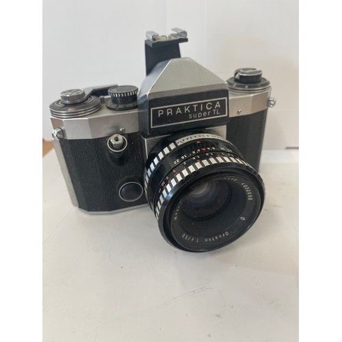 63 - Canon eos 1000f camera and a praktica super tl camera, both untested