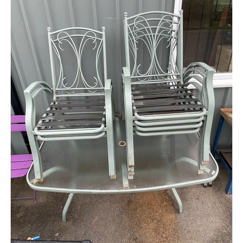 100o - Outside table and 6 chairs, seats have cushion covering