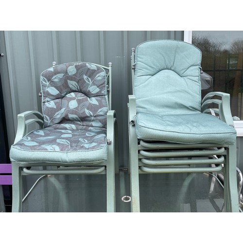 100o - Outside table and 6 chairs, seats have cushion covering